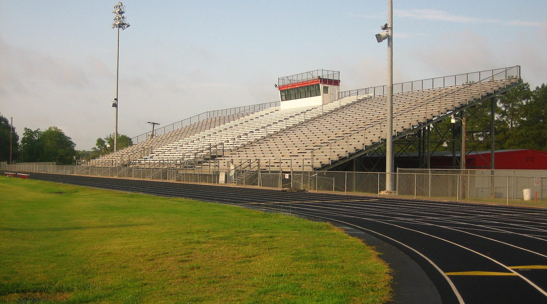 Empty stadium bleachers beside a running track