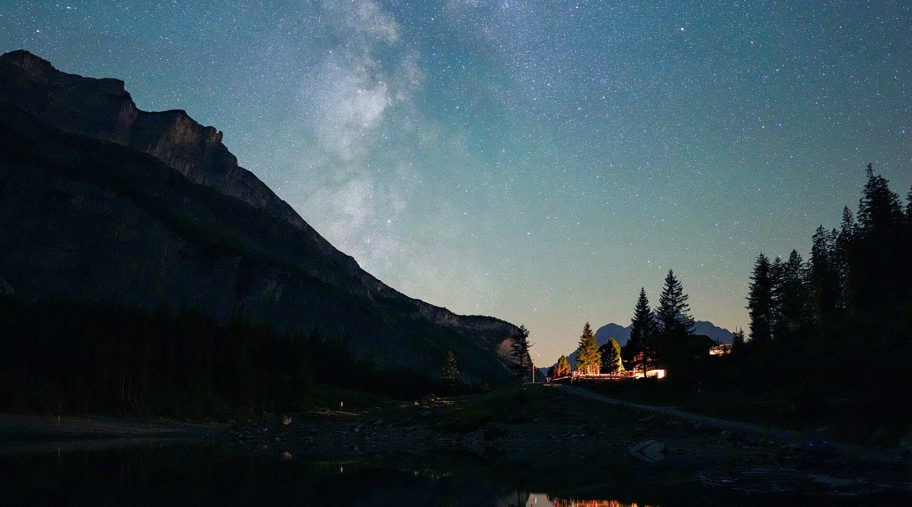 Milky Way reflected over a mountain lake at night